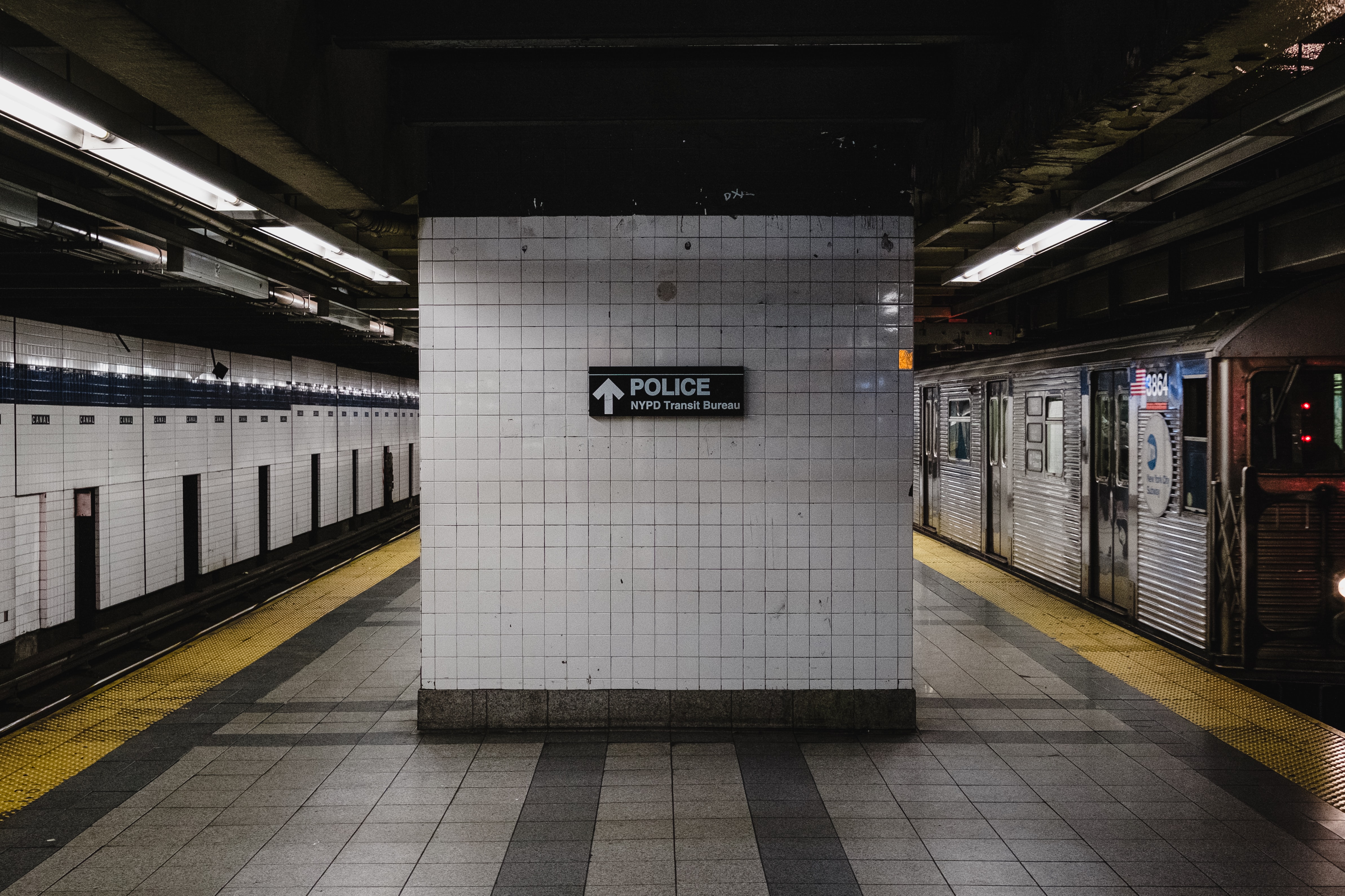 Photo of inside a subway station displaying a Police sign